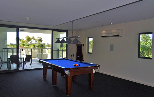 Pool table and outdoor alcove with table and chairs